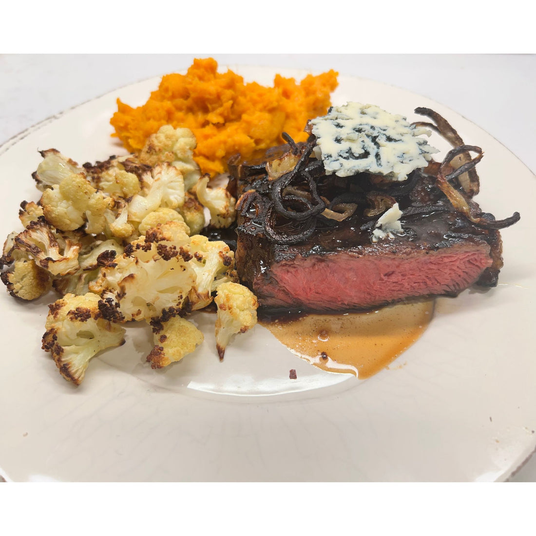 Grilled Beef Filet Topped with Espresso Balsamic-Blue Cheese Reduction and Roasted Shallots